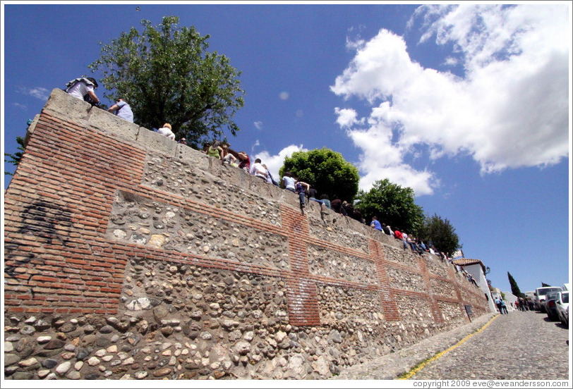 People sitting on the wall.  Mirador de San Nicol?  Albaic?