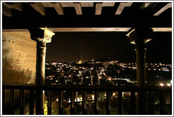 Balcony in Nasrid Palace, Alhambra overlooking Granada at night.