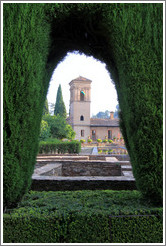 Parador de San Francisco through a hole in the hedge, Alhambra.