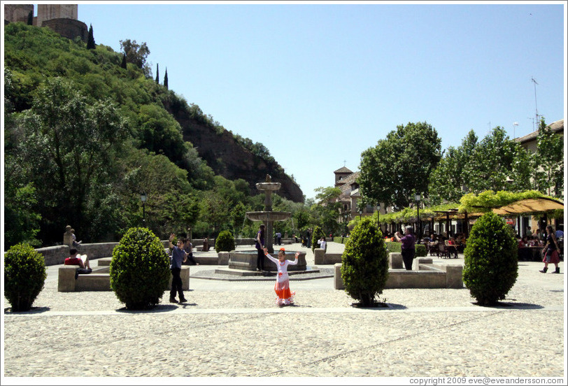 Girl in front of fountain.  Paseo de los Tristes (Promenade of the Sad).  City center.