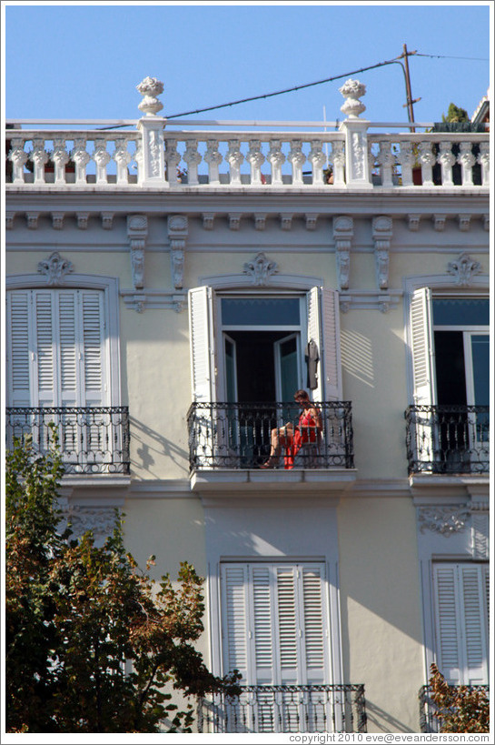 Woman in a red dress on a balcony. Plaza de Bib-Rambla, city center.