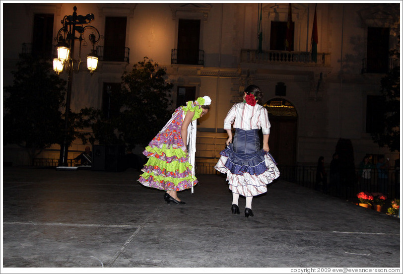Women dancing flamenco on the street at night during the Fiesta de las Cruces.  Plaza del Carmen.  City center.