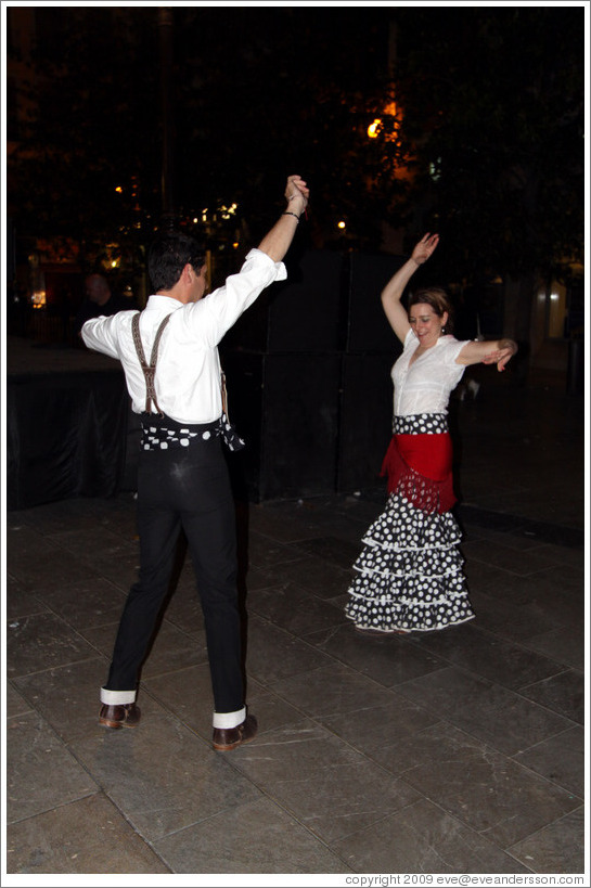 Man and woman dancing flamenco on the street at night during the Fiesta de las Cruces.  Plaza del Carmen.  City center.