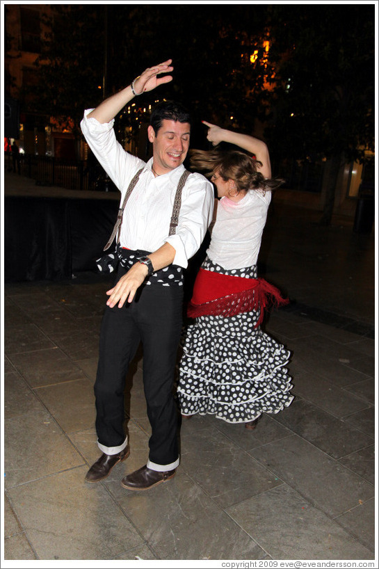 Man and woman dancing flamenco on the street at night during the Fiesta de las Cruces.  Plaza del Carmen.  City center.