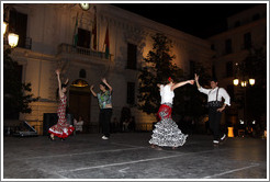 People dancing flamenco on the street at night during the Fiesta de las Cruces.  Plaza del Carmen.  City center.