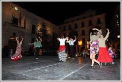 People dancing flamenco on the street at night during the Fiesta de las Cruces.  Plaza del Carmen.  City center.