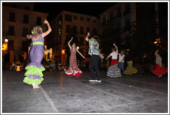 People dancing flamenco on the street at night during the Fiesta de las Cruces.  Plaza del Carmen.  City center.