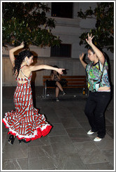 Women dancing flamenco on the street at night during the Fiesta de las Cruces.  Plaza del Carmen.  City center.