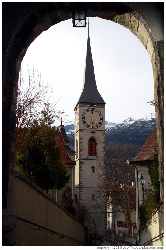 St. Martinskirche, viewed through an arch on Hofsteig, Old Town, Chur.