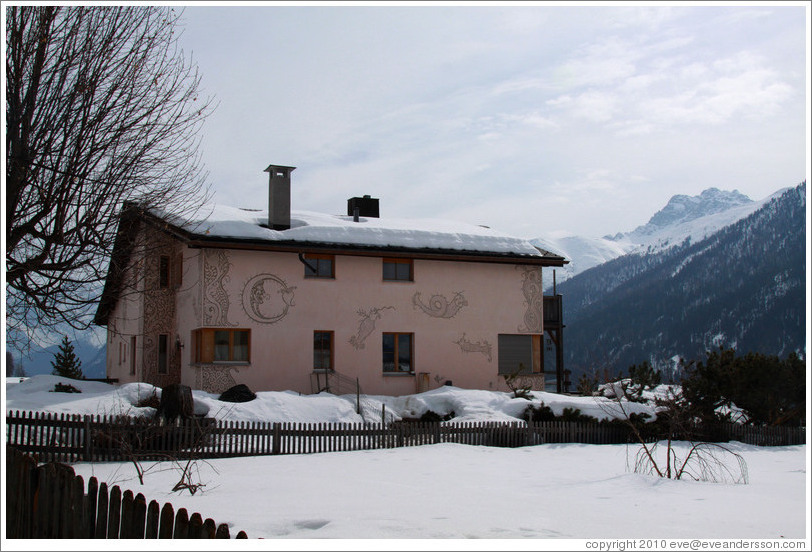 Romansh building, with mountains behind.