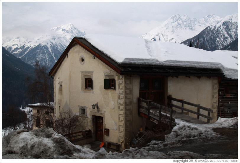 Romansh building, with mountains behind.