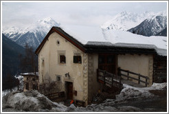 Romansh building, with mountains behind.