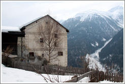 Romansh building, with mountains behind.