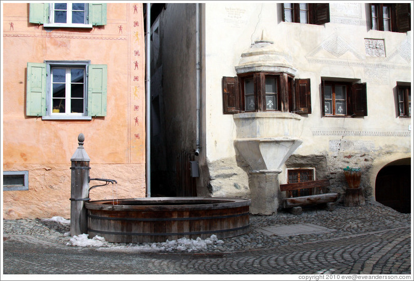 Fountain, with Romansh buildings behind.