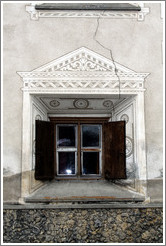 Window, with typical Romansh adornment, and a crack running through the wall.  