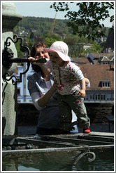 Baby drinking from fountain.  Clean, mountain water comes out of fountains in Z?rich.  Lindenhof.  Altstadt (Old Town).