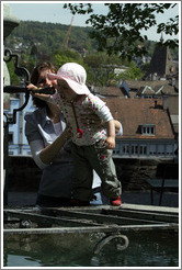 Baby drinking from fountain.  Clean, mountain water comes out of fountains in Z?rich.  Lindenhof.  Altstadt (Old Town).