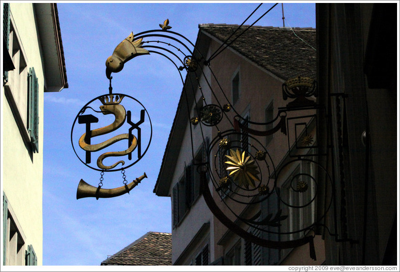Shop sign with snake wearing crown.  Altstadt (Old Town).
