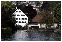 People sunning themselves on the shore of Z?richsee (Lake Z?rich).