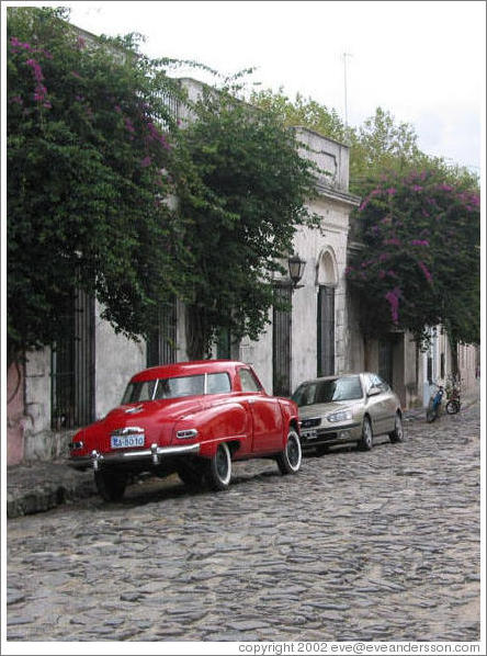 Cobblestone street with old car.