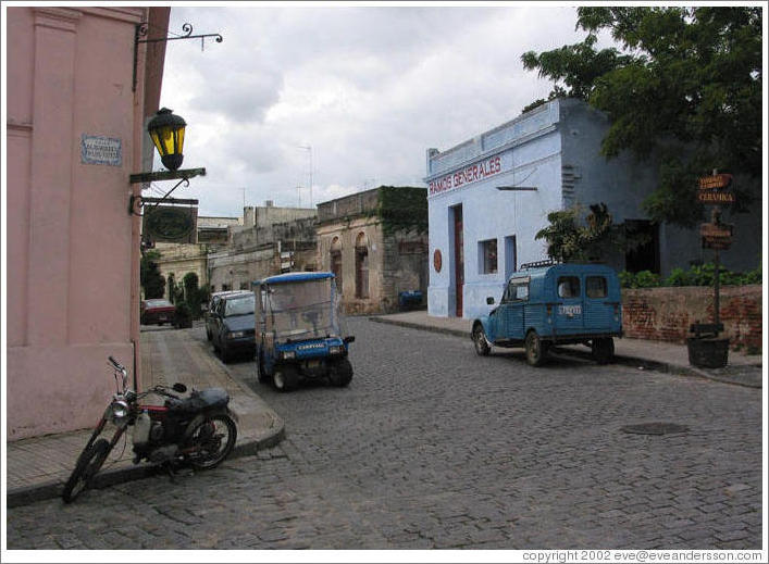 Cobblestone street with old car.