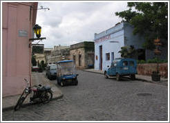 Cobblestone street with old car.