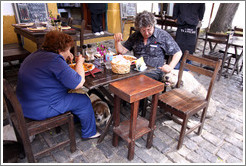 People at a restaurant, with dogs. Calle de Santa Rita, Barrio Hist?o (Old Town).