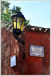 Streetlamp and sign for Calle de los Suspiros (Street of the Sighs).