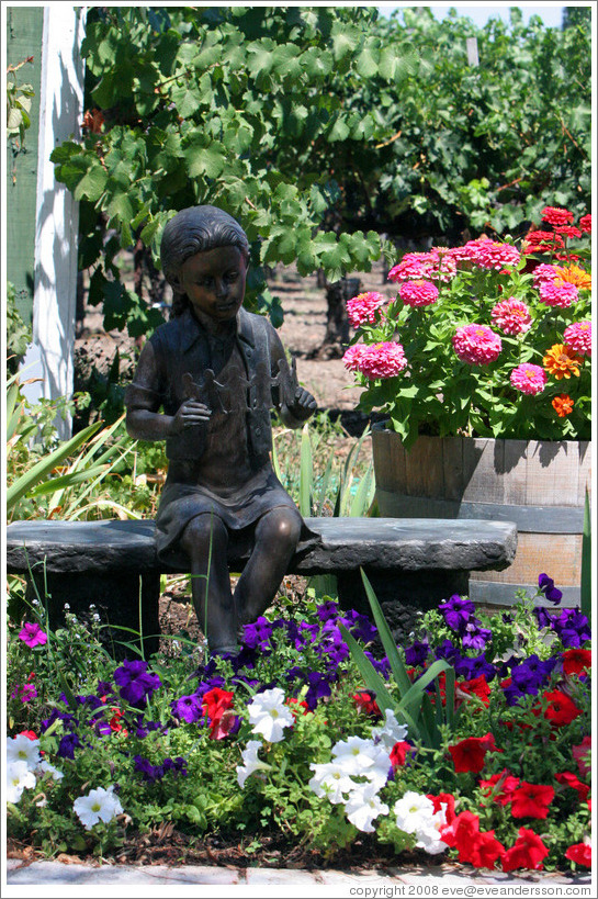 Girl sculpture surrounded by flowers.  Retzlaff Estate Winery.