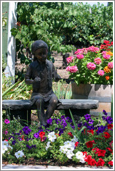 Girl sculpture surrounded by flowers.  Retzlaff Estate Winery.