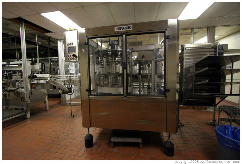 Foil application machine. Bottling line.  Wente Vineyards Estate Winery.