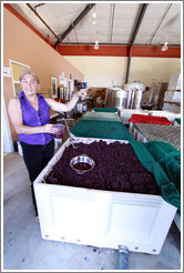 Winemaker Katy Lovell of Poetic Cellars pulling juice from the must (fermenting grape juice).