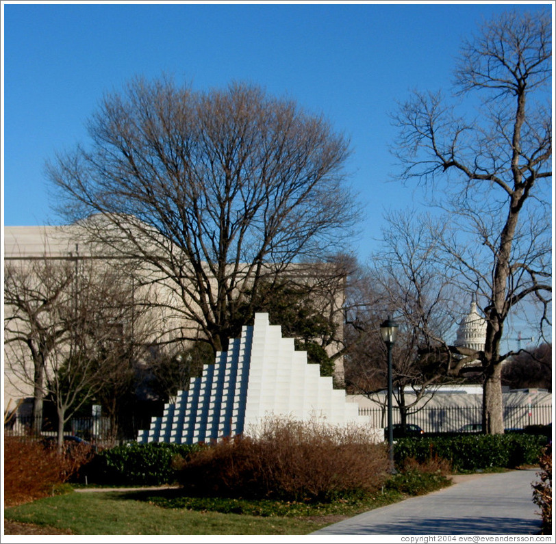 White pyramid at the National Sculpture Garden.  Capitol Building in background.