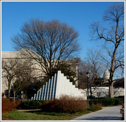 White pyramid at the National Sculpture Garden.  Capitol Building in background.