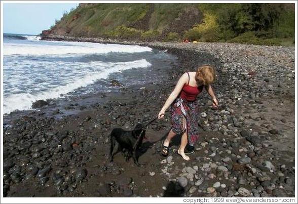 Eve plays with dog.  North coast of Maui.