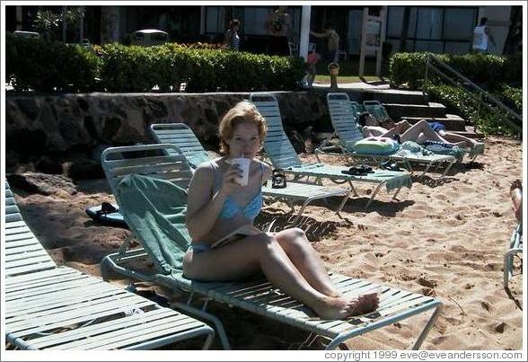 Eve enjoys a tropical drink on the beach.