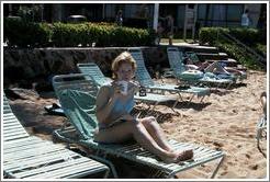 Eve enjoys a tropical drink on the beach. 
