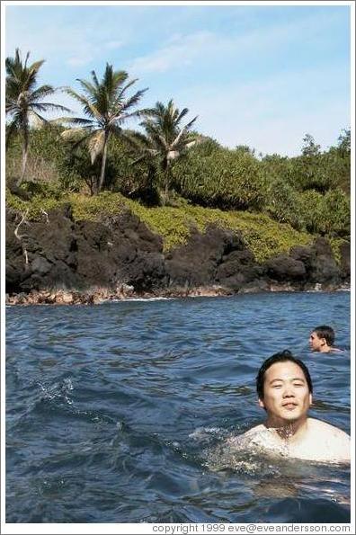 Jin enjoys the clear water at the beautiful black sand beach. Hana, Maui.