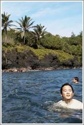 Jin enjoys the clear water at the beautiful black sand beach. Hana, Maui.