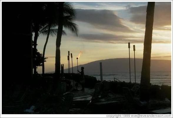 Lighting the lamps. Kaanapali, Maui. 