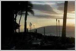 Lighting the lamps. Kaanapali, Maui. 