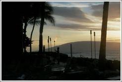 Lighting the lamps. Kaanapali, Maui. 