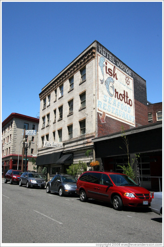 Downtown building, with old Fish Grotto sign painted on side.