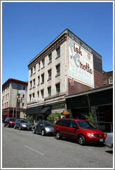 Downtown building, with old Fish Grotto sign painted on side.