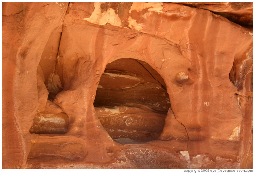 Hole in a vertical rock face.