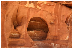 Hole in a vertical rock face.