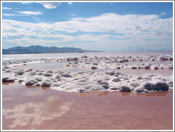 Pink water with white salt crystals, near the Spiral Jetty.  Reflections of clouds.