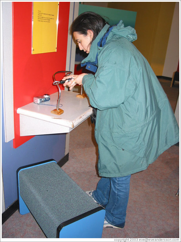 Lissette trying to keep hand steady.  Pacific Science Center.