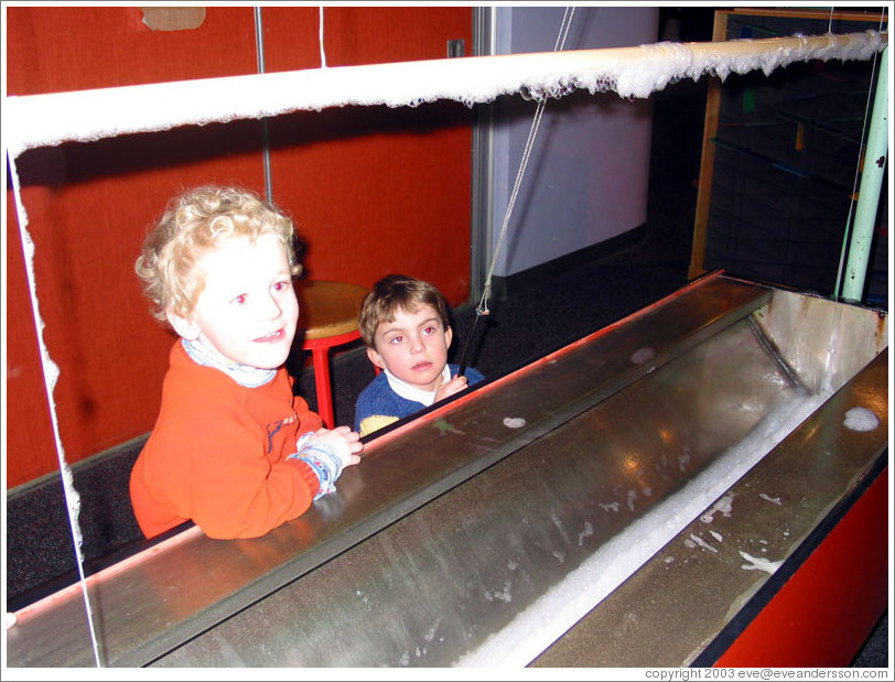 Children creating a huge bubble at the Pacific Science Center.