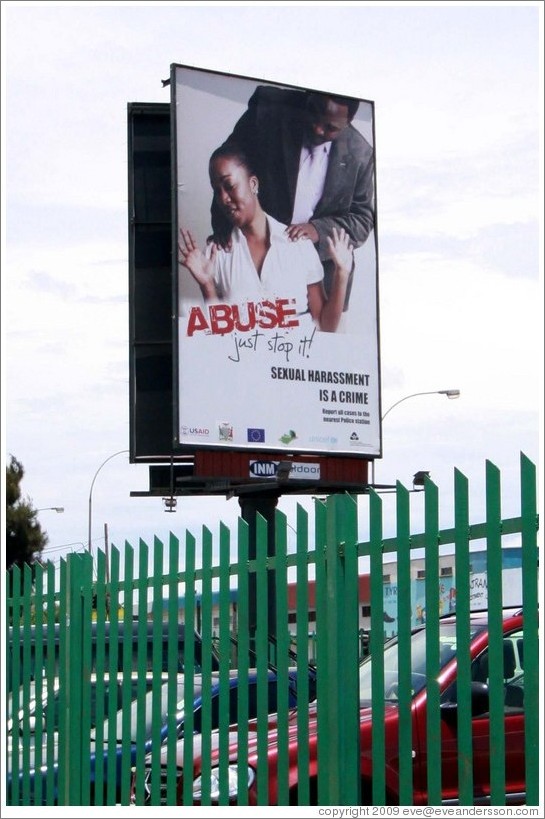 Billboard reading "Abuse / just stop it / Sexual harassment is a crime".